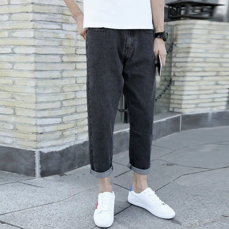 Men's loose straight harem jeans in black cotton fabric showing straight leg opening