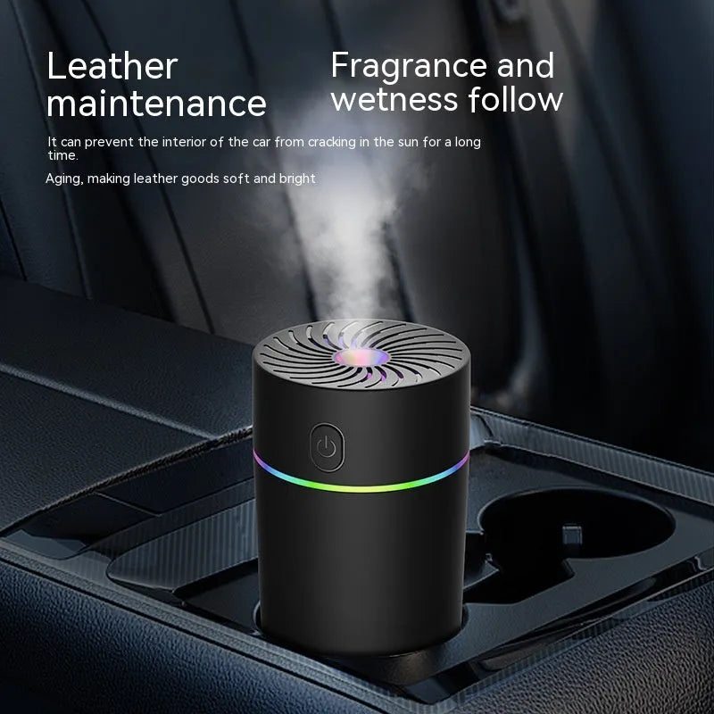 Compact black car USB humidifier with aromatherapy function placed in a vehicle cup holder.