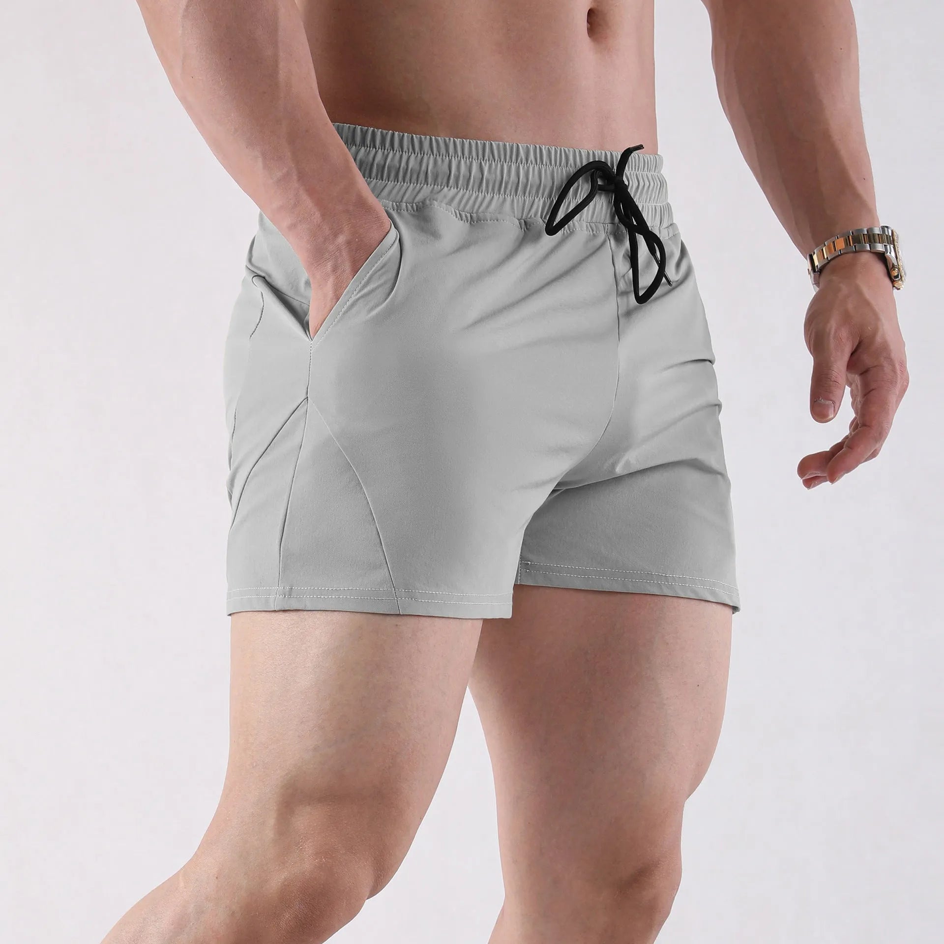 Men's grey polyester basketball shorts with elastic waistband on a white background.