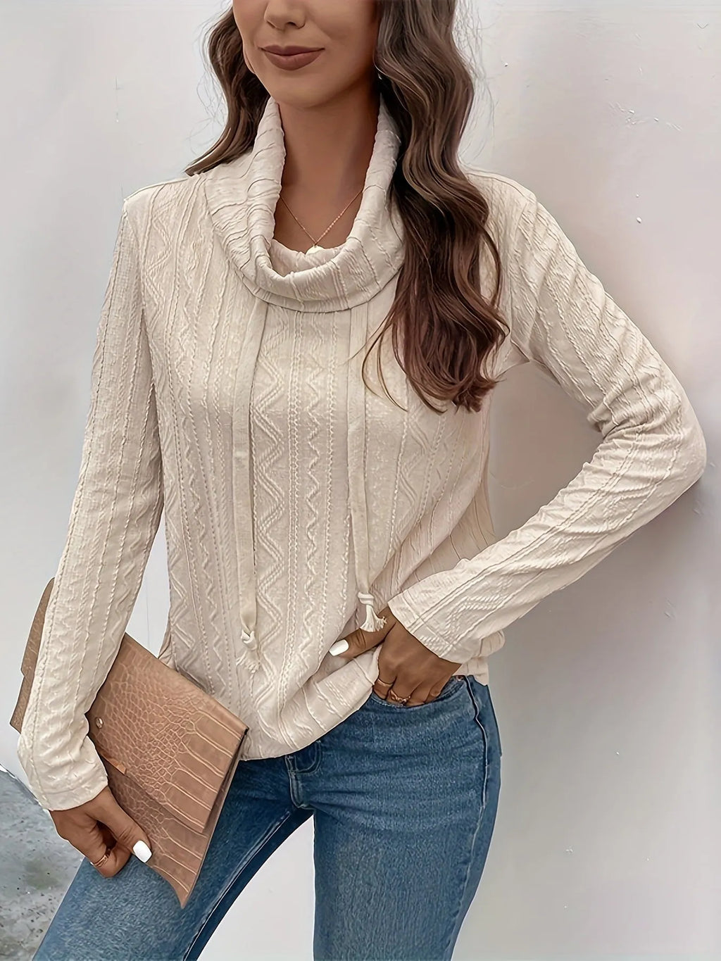 Apricot coloured long sleeve hooded pullover sweater with a drawstring hood on a hanger.