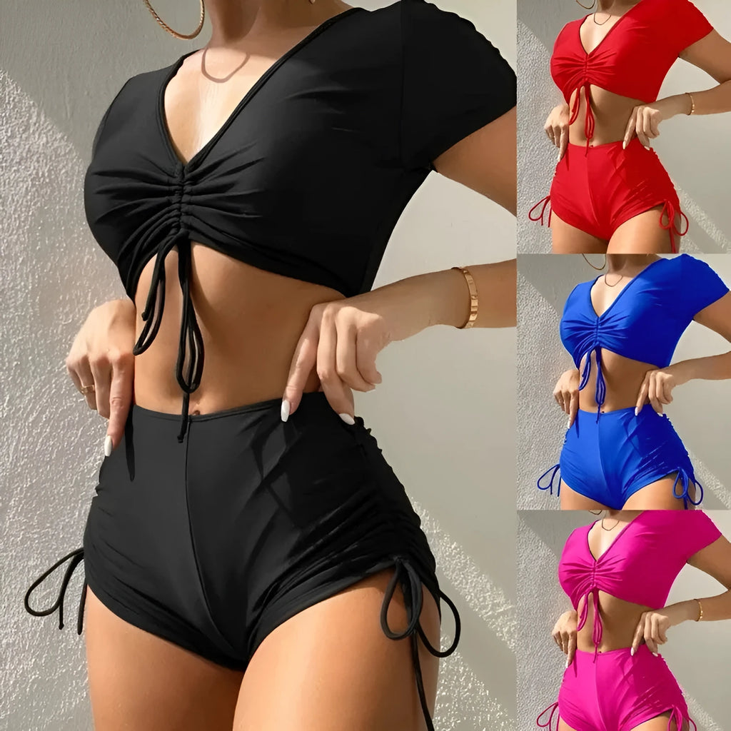 Women's dark green lace-up front swimsuit top with bow and matching shorts
