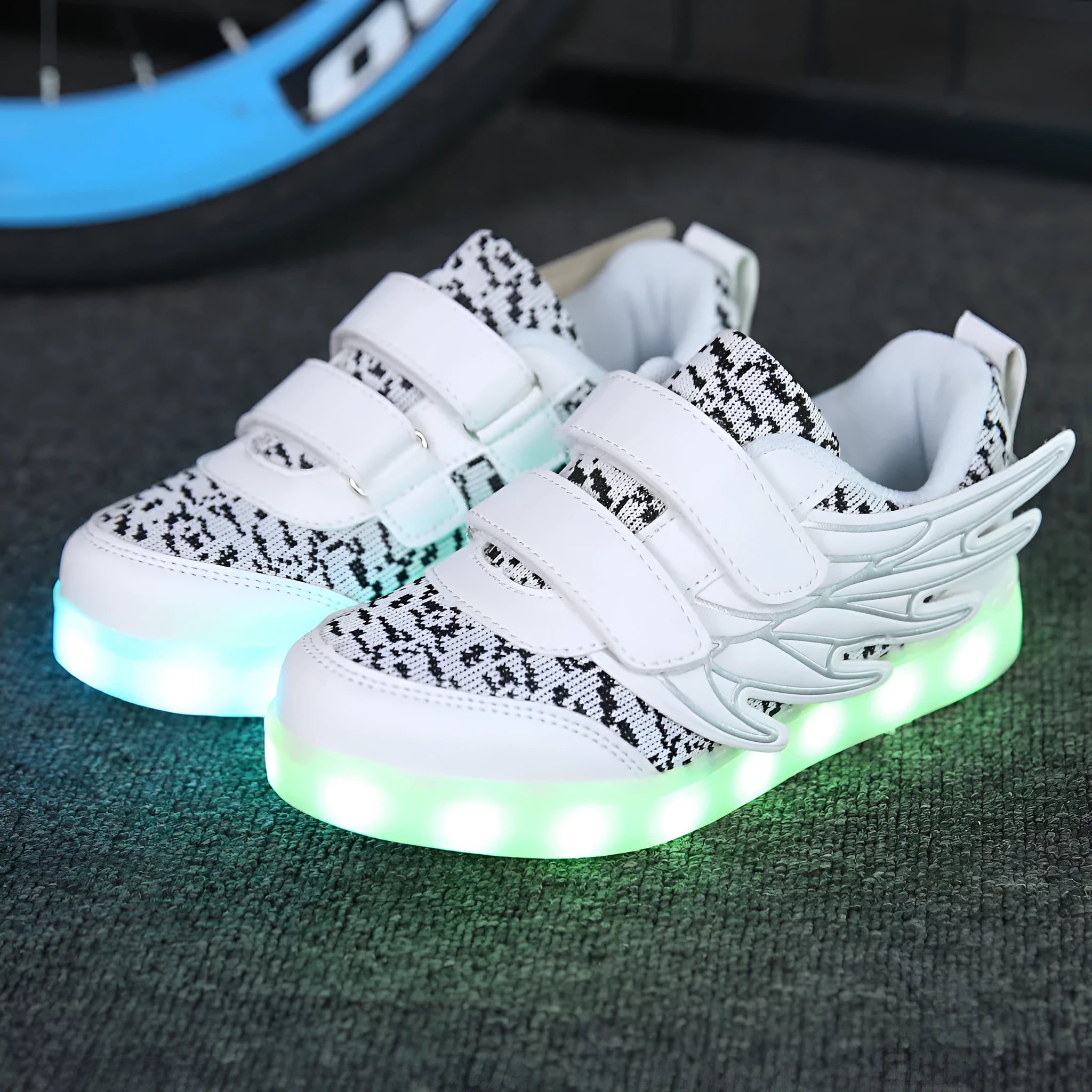 USB rechargeable children's LED light up trainers in plum red and white showing flashing soles.