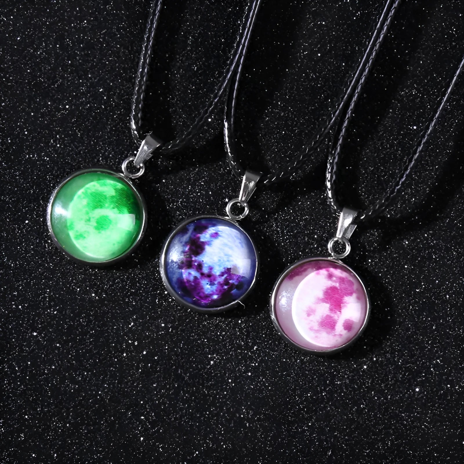 Close-up of a luminous alloy necklace with a blue organic glass constellation pendant on a model.