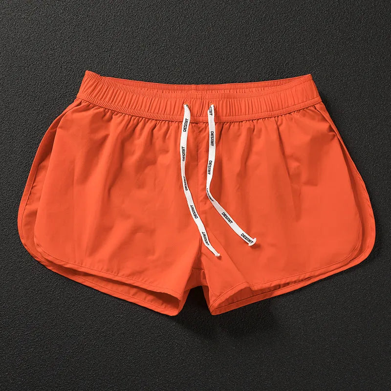 Men's loose-fit beach surf shorts in polyester available in orange, green or black colours