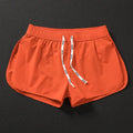 Men's loose-fit beach surf shorts in polyester available in orange, green or black colours