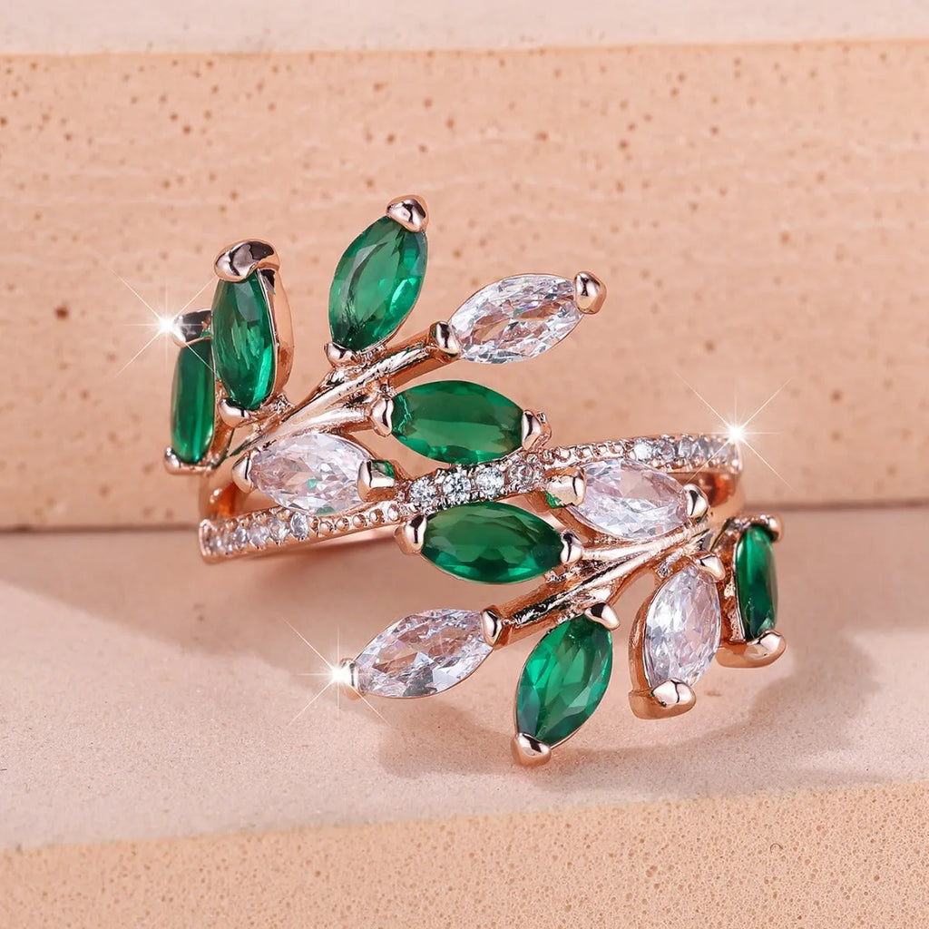 Adjustable opening copper leaf fashion ring with sparkling zirconia stones in a rose gold finish.