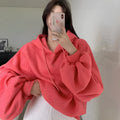 Watermelon red women's sleeveless hooded sweater made from mulberry silk fabric on a hanger.
