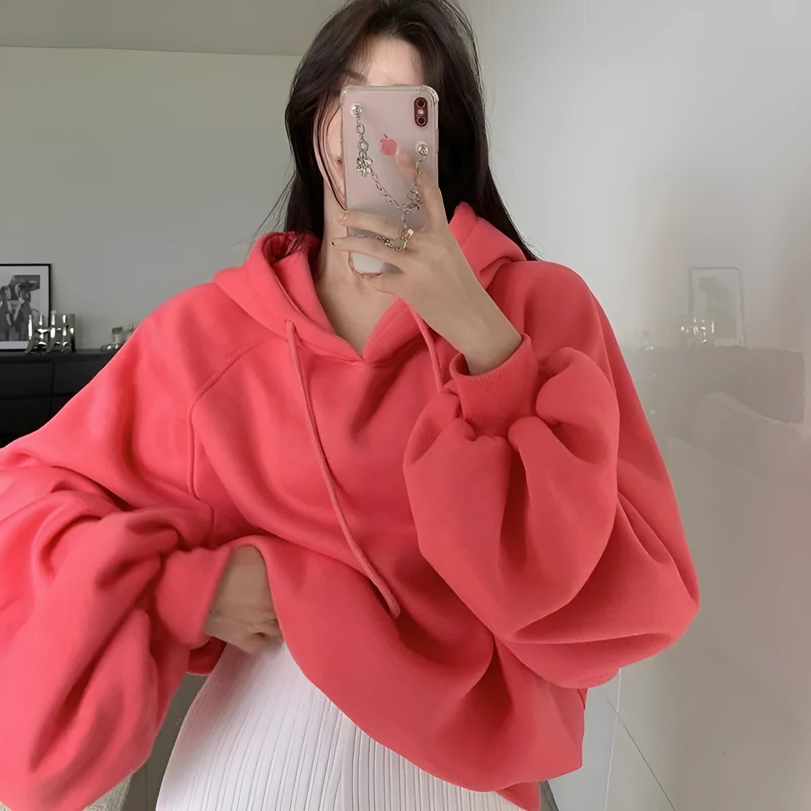 Watermelon red women's sleeveless hooded sweater made from mulberry silk fabric on a hanger.