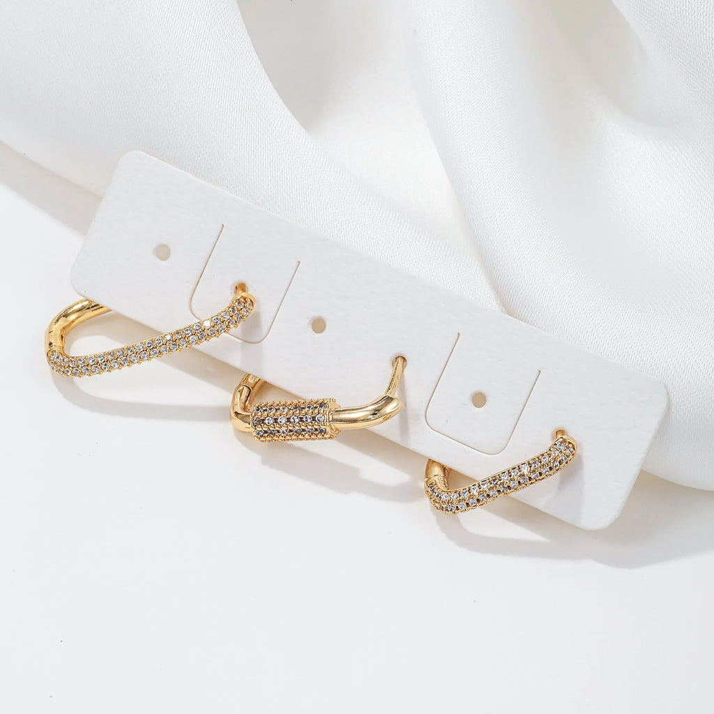 Three geometric ear clips with micro inlaid zircon in gold and white metal colours