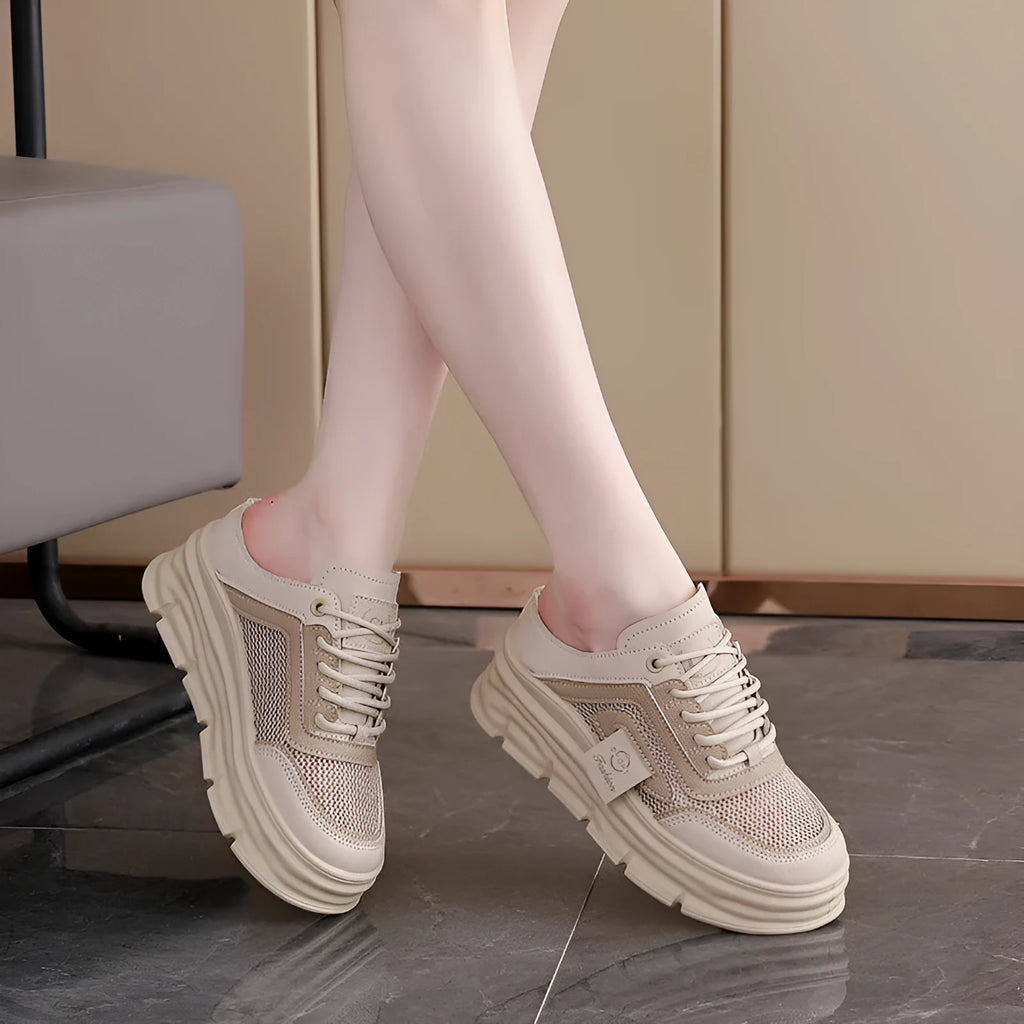 Women's black mesh half slipper with round toe, rubber sole, and height increase insole.