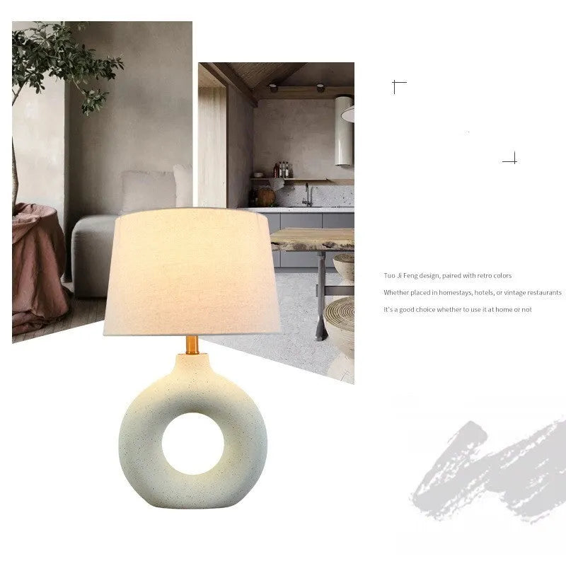 Small white Japanese style Feng Pottery Pot table lamp with ceramic base and fabric shade on a desk.