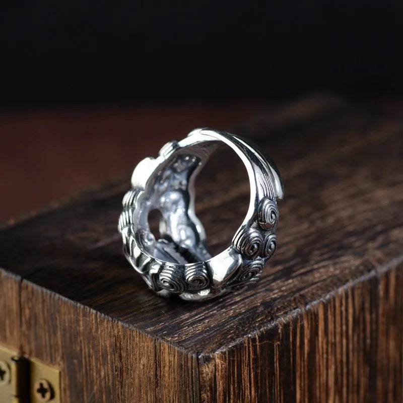 Silver open style ring with a detailed jibeast animal zodiac pattern.