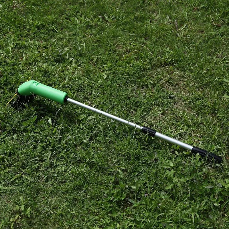 Cordless electric lawn trimmer with extension pole and black debris shield on a green lawn.