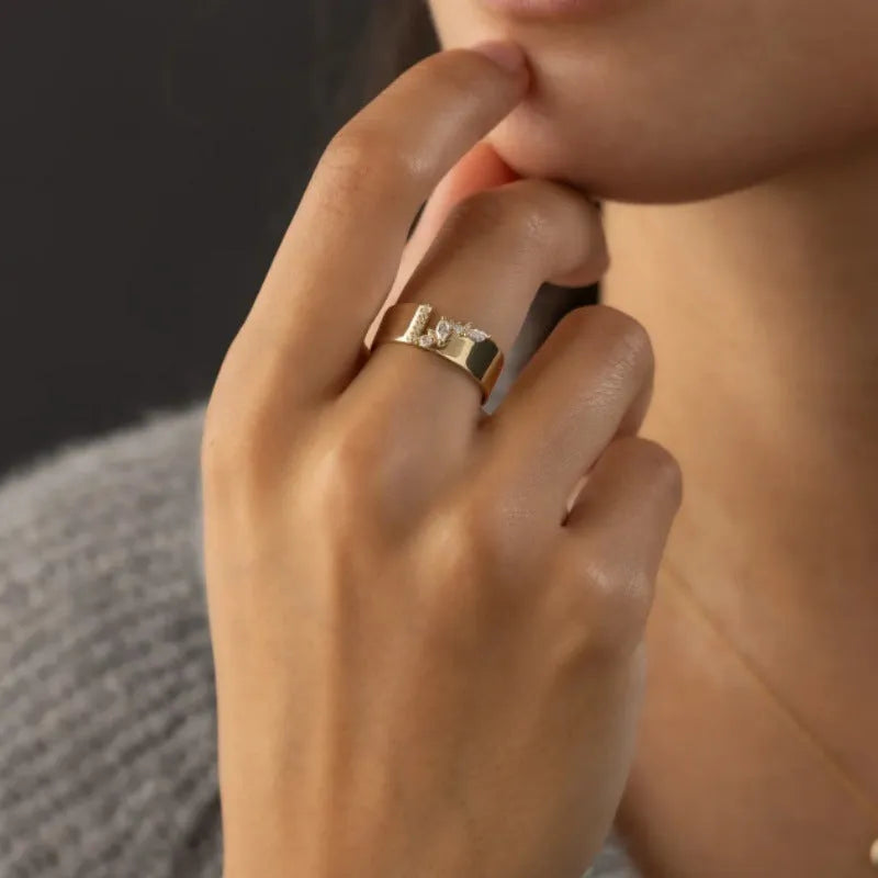 Gold-coloured electroplated copper band ring for women shown on a finger.