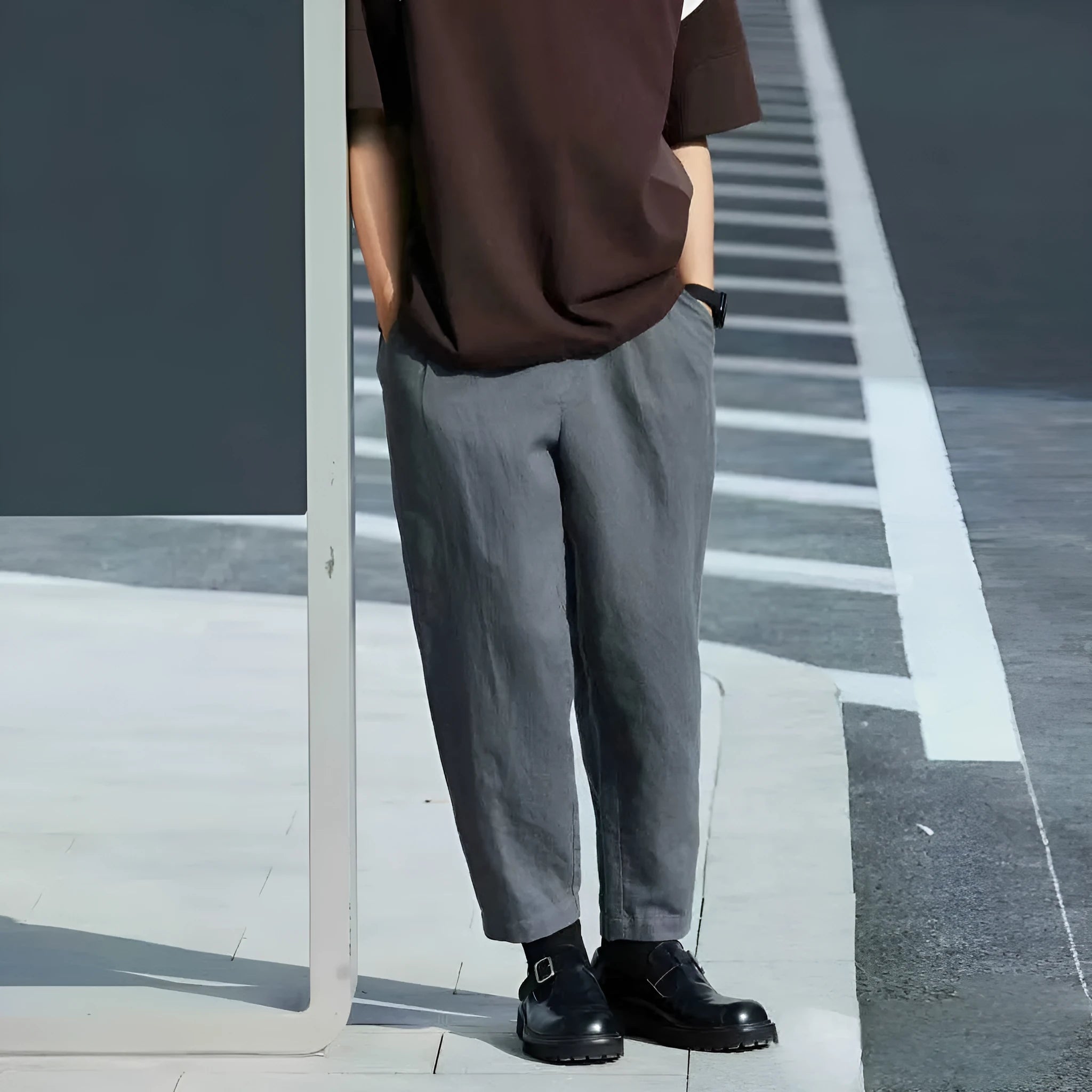 Man wearing loose straight-leg casual trousers in beige with a drawstring waistband.
