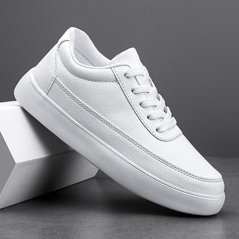 Women's white leather lace-up flat casual shoes on a neutral background.