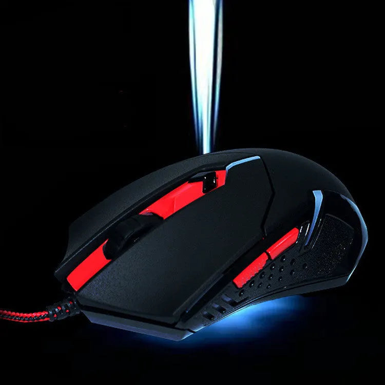 Black and red wired USB ergonomic gaming mouse with six buttons on a desk.
