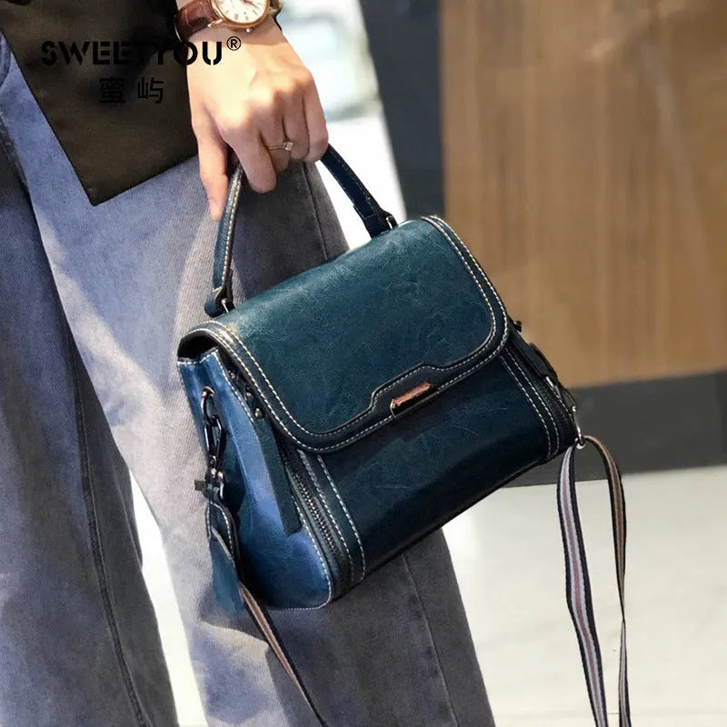 Women's genuine leather messenger bag in retro styling with multiple internal compartments