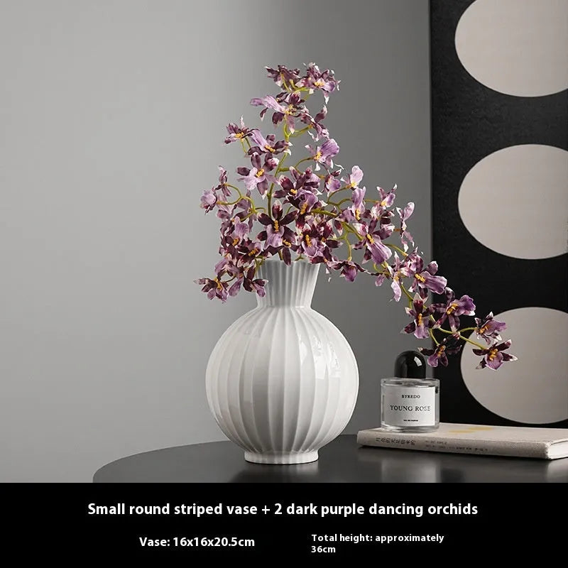 White ceramic ball-shaped vase with striped American country design on a table.