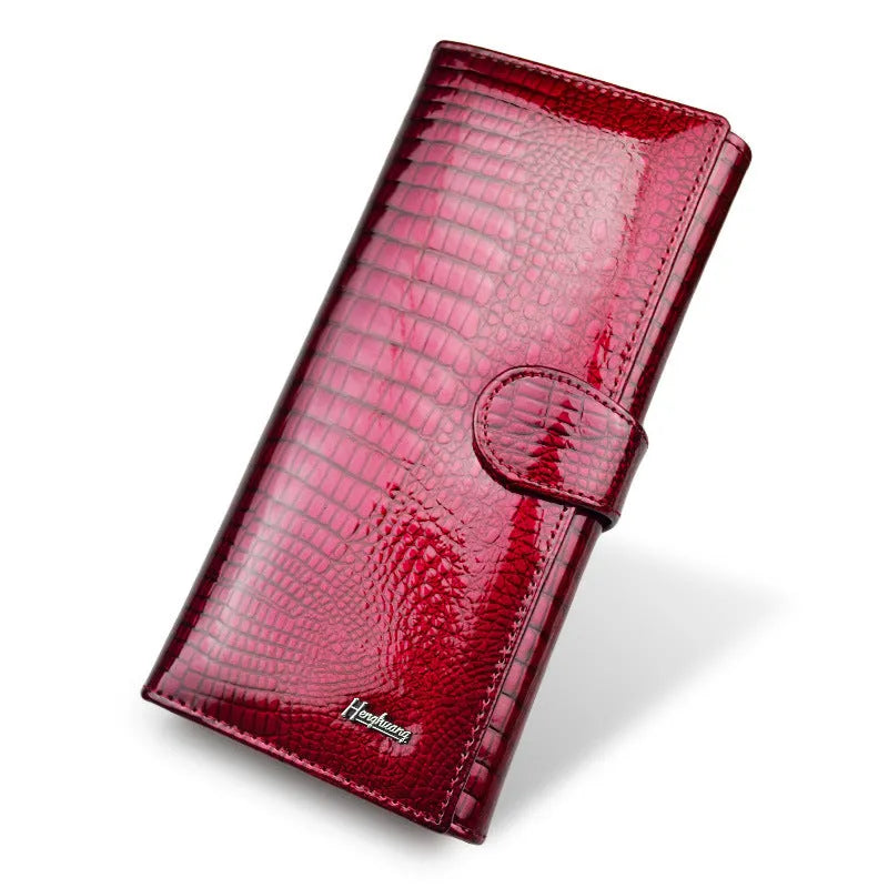 Women's leather coin purse with crocodile pattern embossing in red colour showing interior pigskin lining