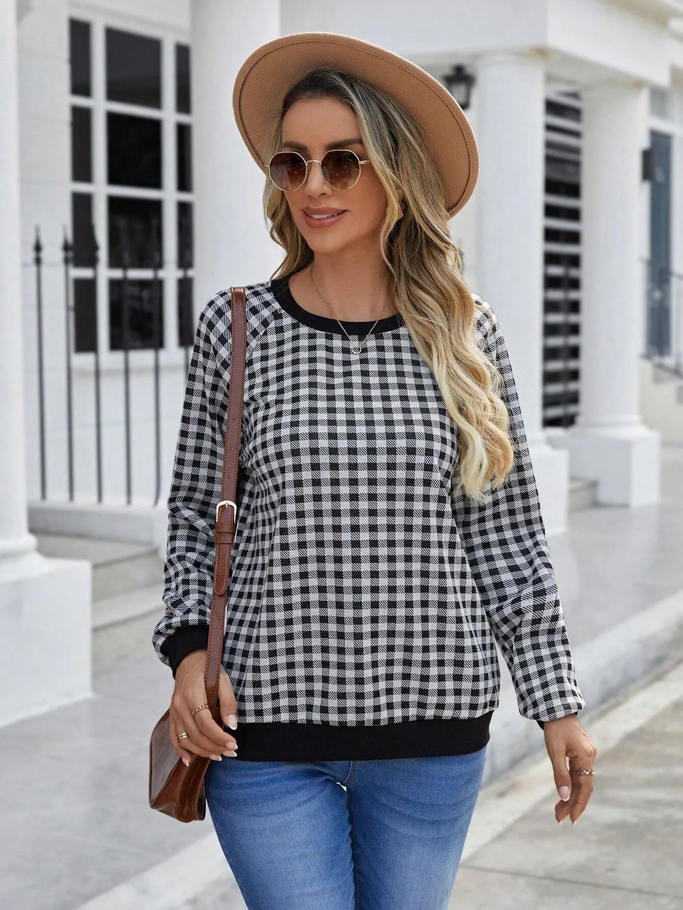 Black long sleeve pullover sweater with a Japanese plaid pattern, shown on a hanger.