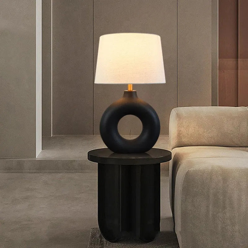 Small white Japanese style Feng Pottery Pot table lamp with ceramic base and fabric shade on a desk.