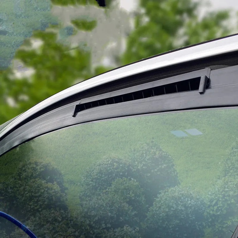 Black and white USB-powered car ventilation fan for exhaust odour removal on windowsill.