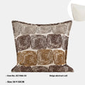 Square and rectangular pillow covers with cream and coffee abstract coil pattern on a sofa.