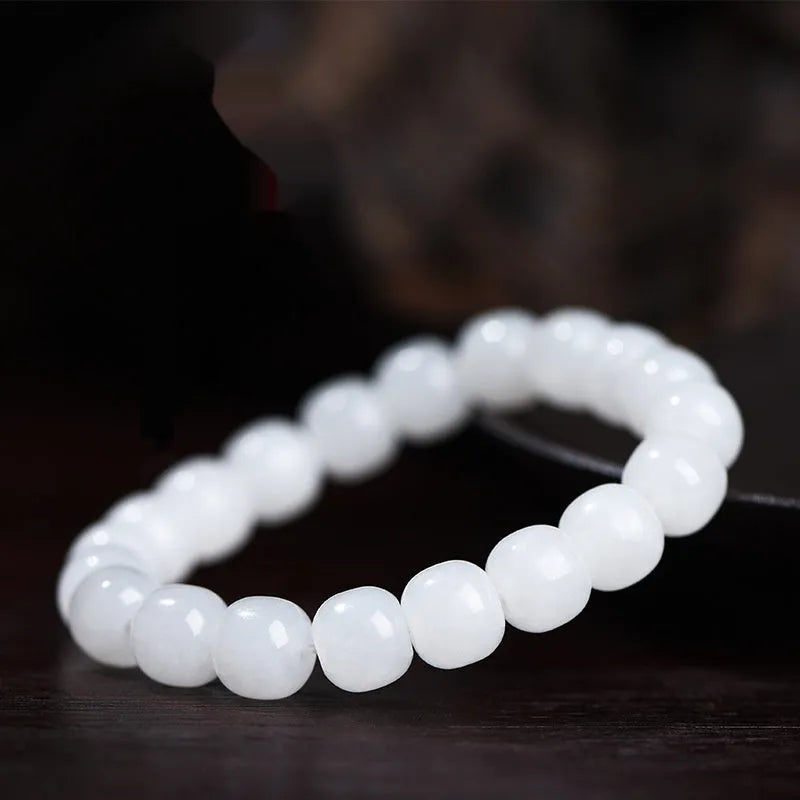 White Hetian jade barrel bead bracelet showing three size options on a neutral background