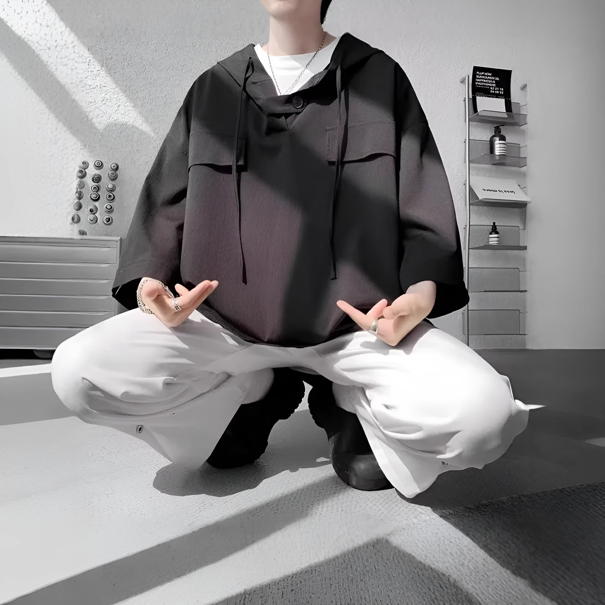 Man wearing a loose fit black hooded short sleeve t-shirt for summer.