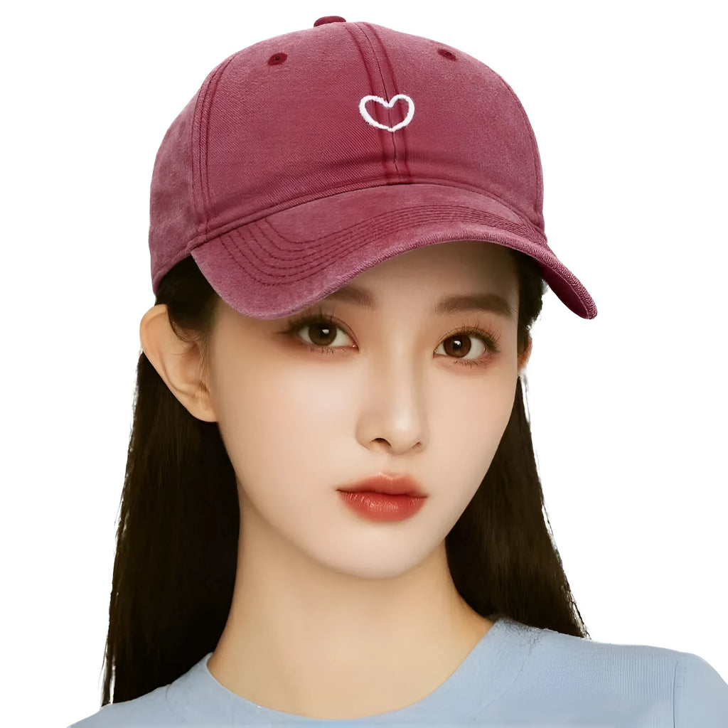 Retro baseball cap with embroidered heart design on front, adjustable back strap, dome crown