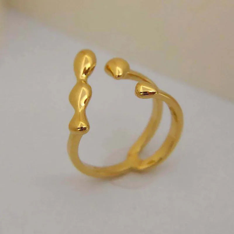 Brass adjustable fashion ring with spherical detail in gold or silver finish.