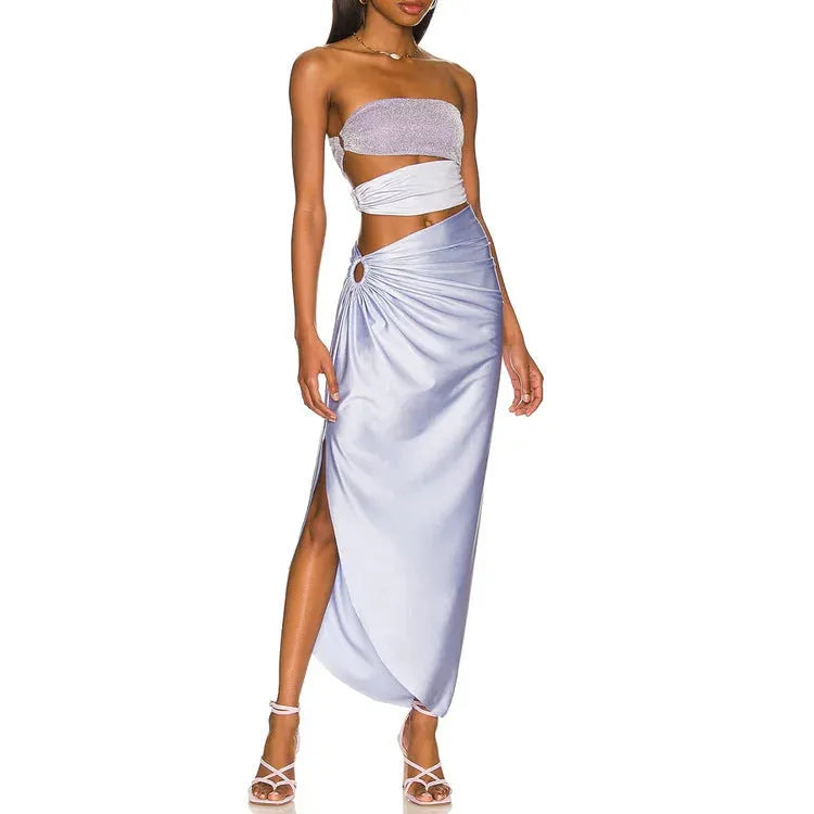 Purple one-piece swimsuit with hollow design and matching wrap skirt on a model.