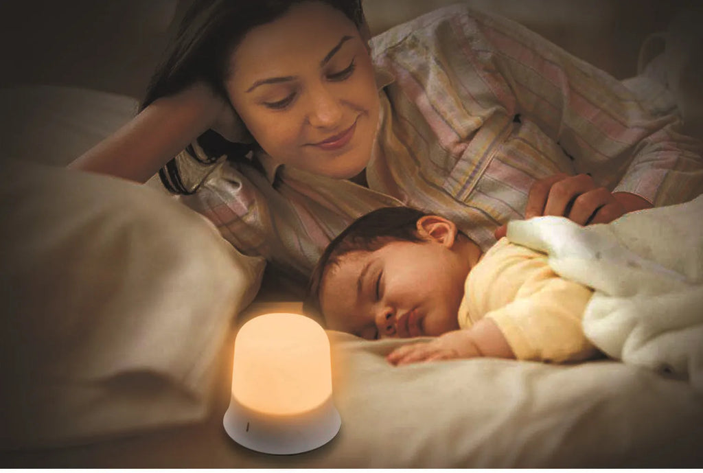 White touch-control baby night light with motion sensor on a nursery bedside table.