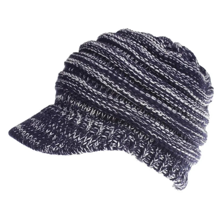 Woman wearing a soft knitted beanie with a ponytail pulled through the opening in the crown.