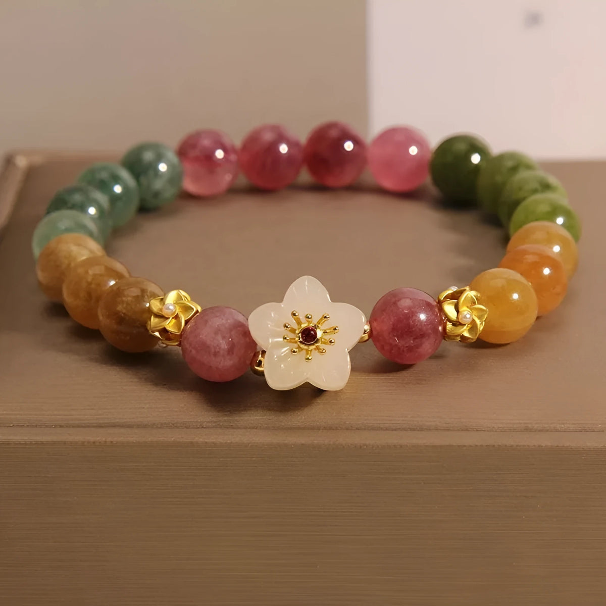 Natural colour tourmaline bracelet with floral and fu character designs and electroplated finish