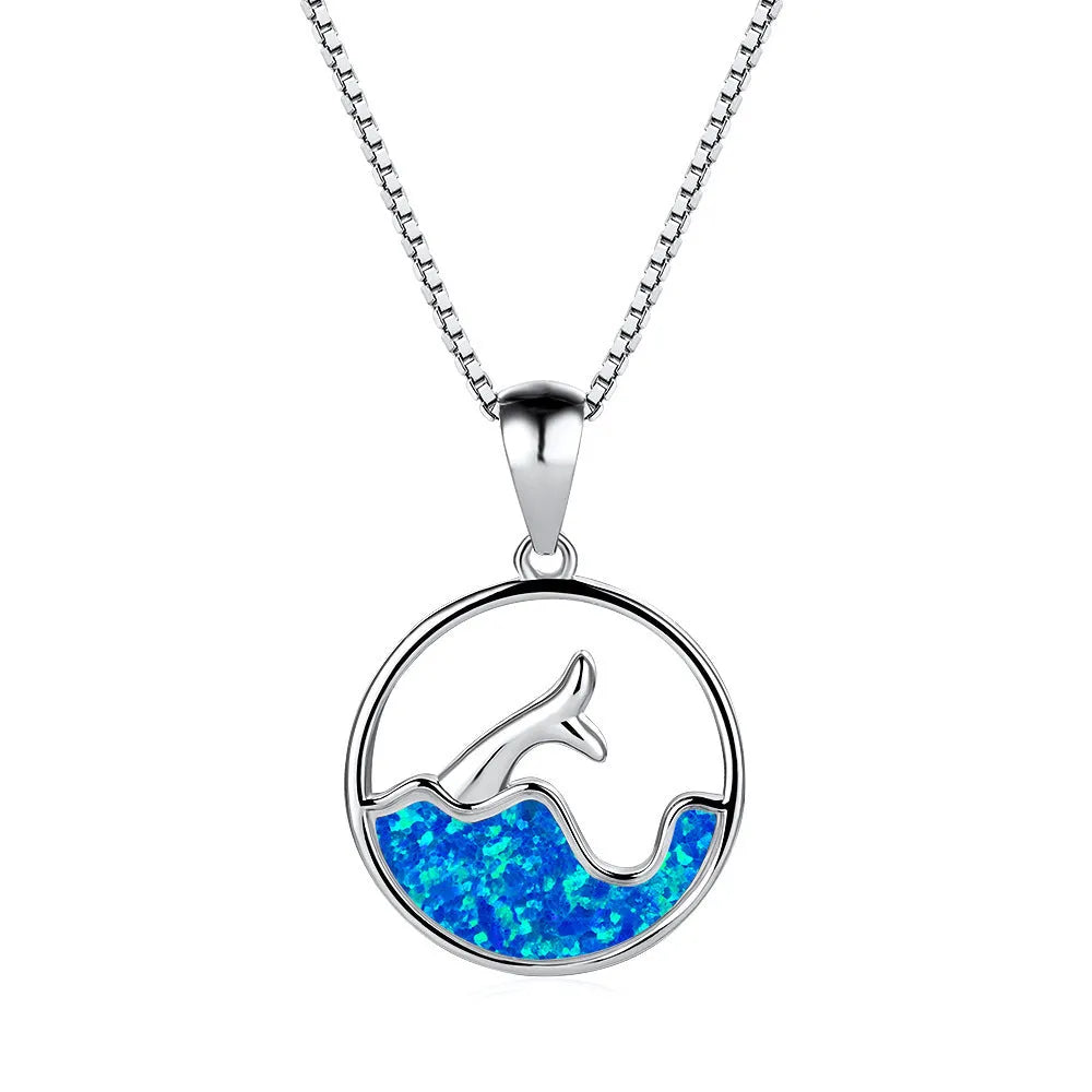 Geometric white gold fishtail necklace with round blue opal centre on model