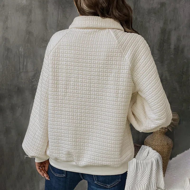 Beige women's knitted sweater with a polo collar and long sleeves laid flat.