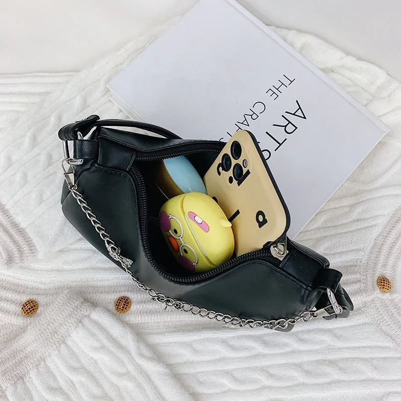 Women's black butterfly design chain underarm bag with a squared shape and three-dimensional pocket.