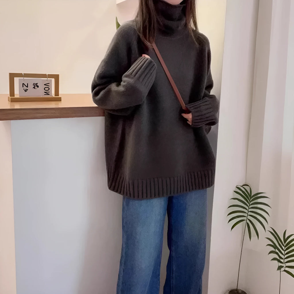 Red women's loose turtleneck sweater with a textured curling pile collar, shown in a casual setting.