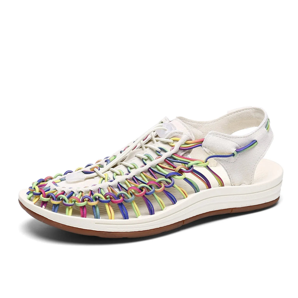 Woven drawstring Roman sandals in a rainbow colour with an elastic fastening and rubber sole.