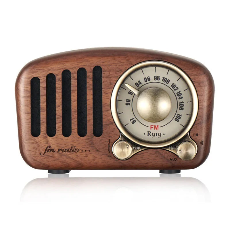 Compact retro wooden Bluetooth mini speaker in cherry wood finish showing front grille and wood grain.