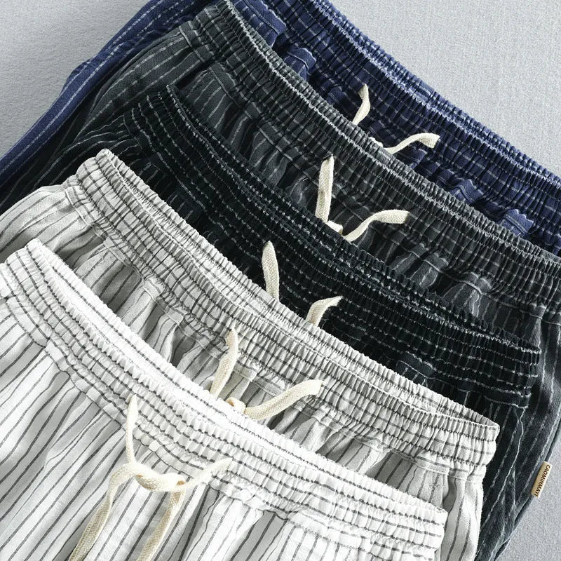 Men's striped casual shorts in cotton with elastic waist, showing loose straight fit and colour options.