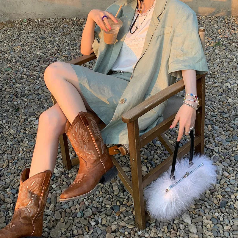 Brown women's embroidered mid-calf Martin boots with a square heel and leather lining.