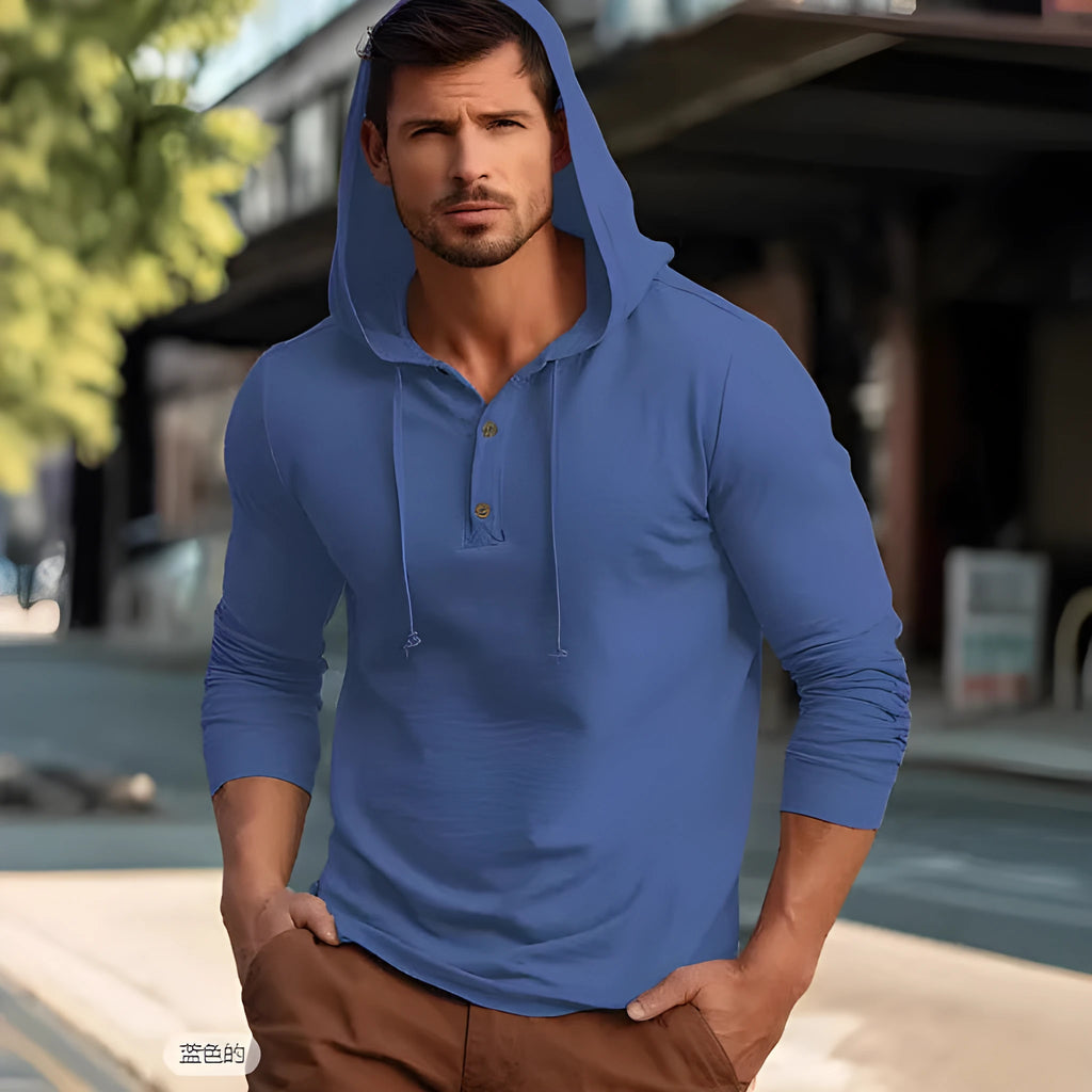 Man wearing a dark blue casual cotton hoodie pullover with long sleeves.