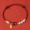 Women's bracelet with Hetian Jade and cinnabar beads on adjustable 925 silver chain.