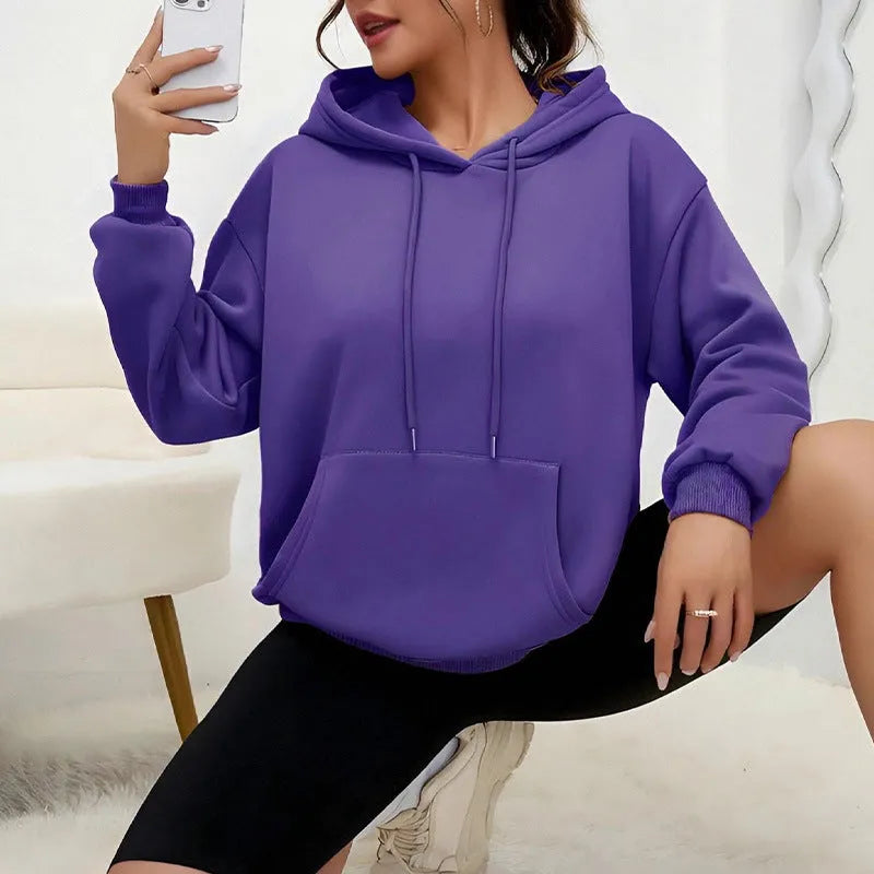 Women's loose fit grey hooded sweatshirt with drawstring and front pocket, long sleeves.