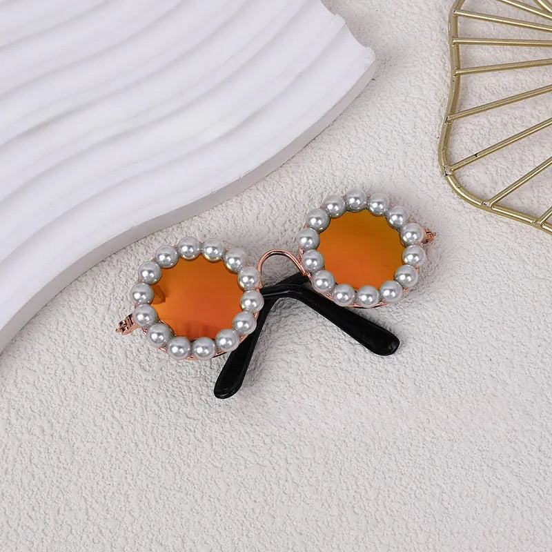 Pearl-rimmed round sunglasses on a cat and dog for costume dress up