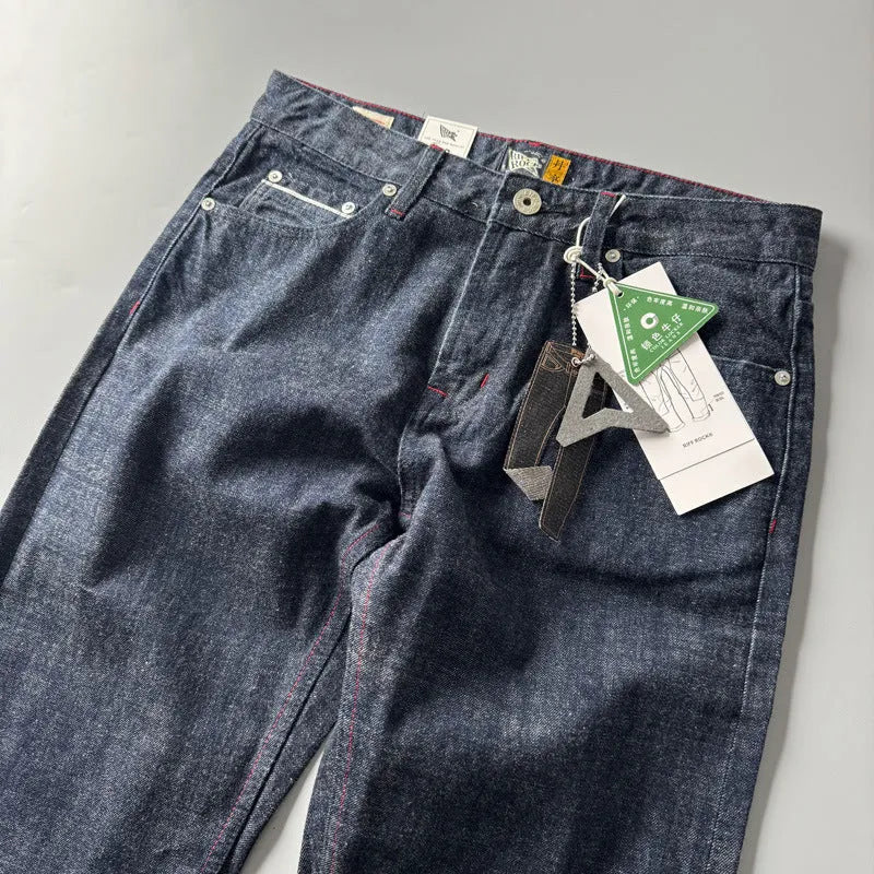Men's straight leg denim trousers in a primary colour, showing the mid waist fit and long leg.