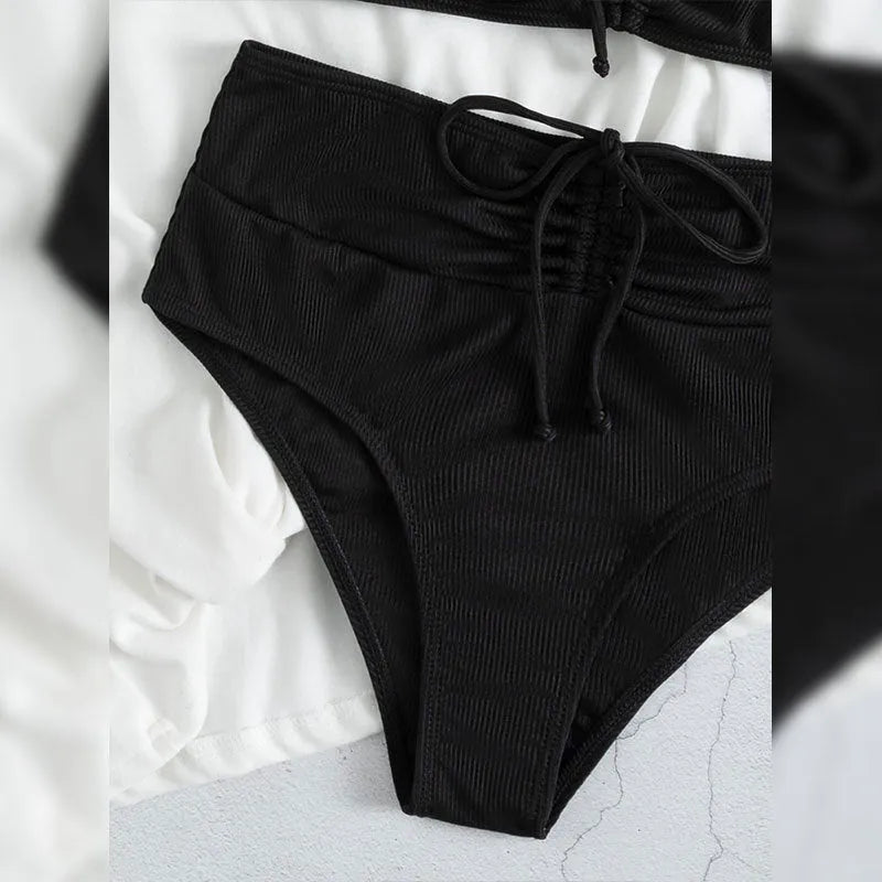 Black women's high-waisted bikini with sling split shorts and sleeveless top